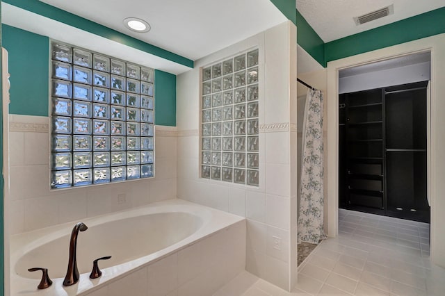 bathroom with tile floors and tiled bath