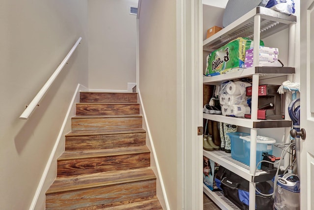 staircase with hardwood / wood-style flooring