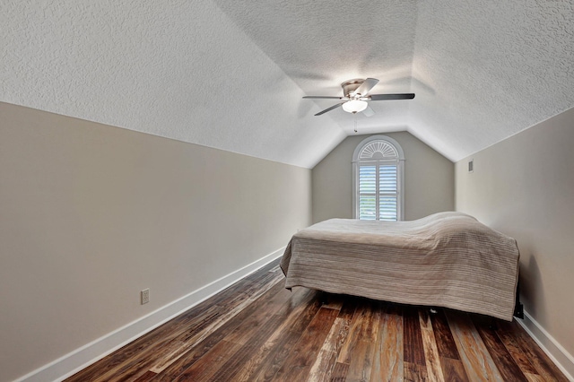 bedroom with ceiling fan, lofted ceiling, a textured ceiling, and hardwood / wood-style flooring