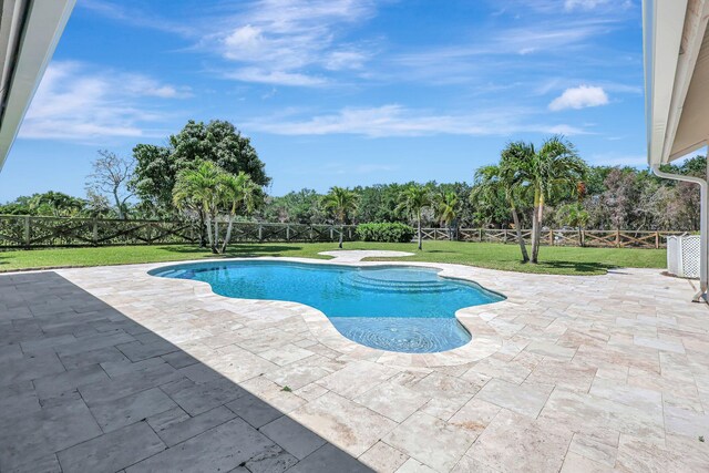 view of swimming pool with a yard and a patio