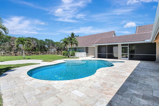 view of swimming pool featuring a patio area and a lawn