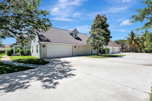 view of front of property featuring a garage and a front lawn