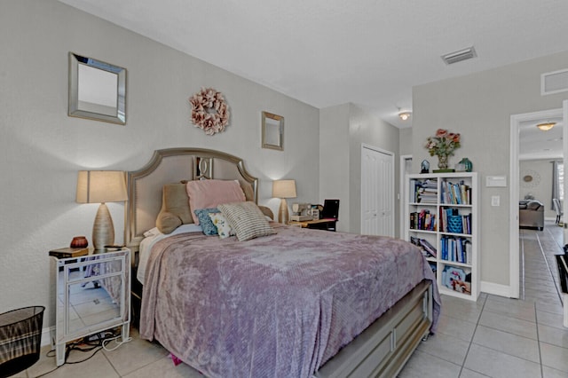 tiled bedroom featuring a closet