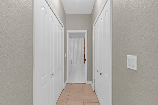 hall with light tile flooring