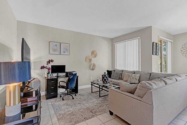 tiled living room featuring a textured ceiling