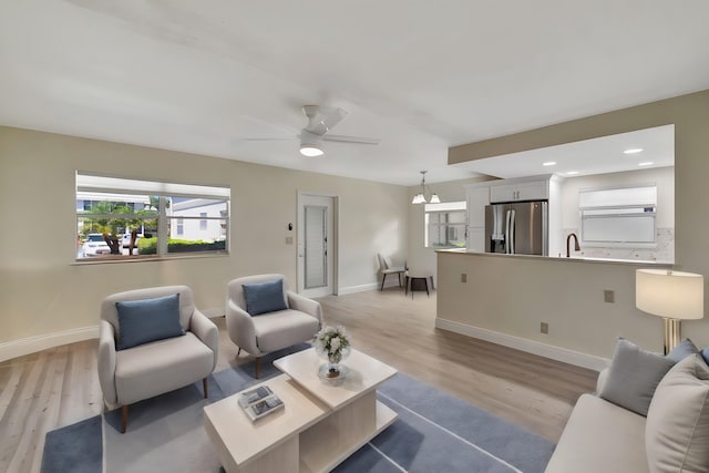 bedroom featuring light hardwood / wood-style floors, multiple windows, and ceiling fan