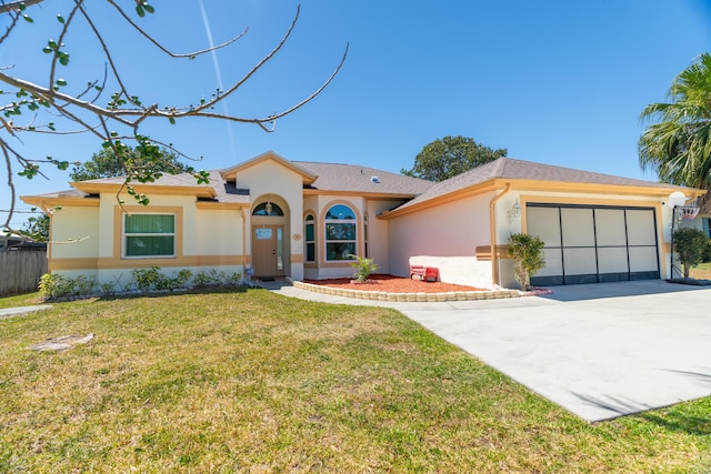 view of front of house featuring a garage, a front yard, and stucco siding