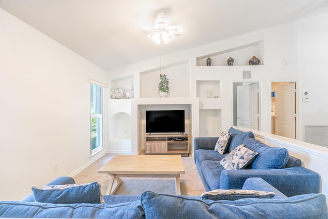 carpeted living room featuring built in features, ceiling fan, and vaulted ceiling