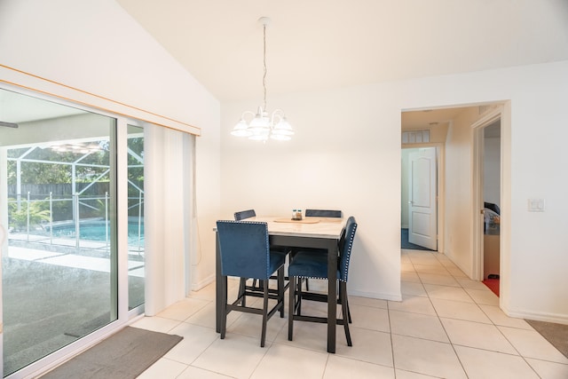 dining room with vaulted ceiling, light tile floors, and a chandelier