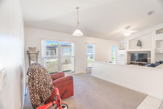 sitting room featuring light colored carpet and ceiling fan