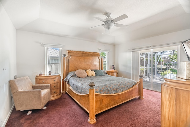 carpeted bedroom with ceiling fan, access to outside, and a raised ceiling