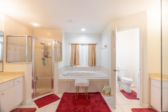 full bathroom with vanity, tile floors, toilet, and shower with separate bathtub