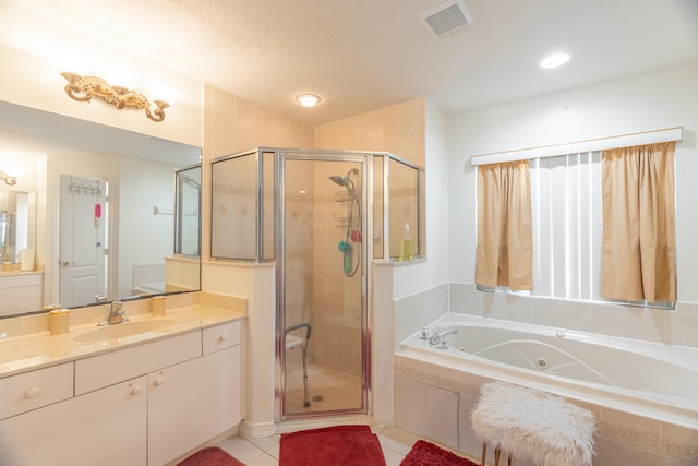 bathroom featuring a textured ceiling, independent shower and bath, vanity, and tile flooring