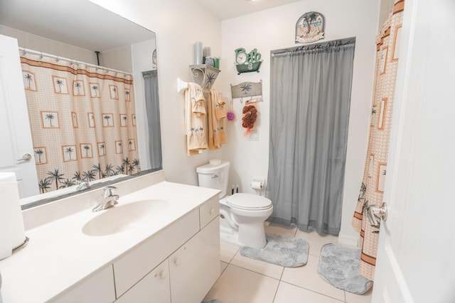 bathroom with tile flooring, toilet, and large vanity