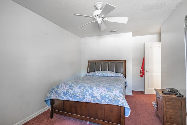 carpeted bedroom featuring a textured ceiling and ceiling fan