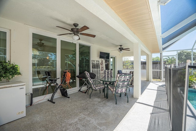 view of terrace featuring a lanai and ceiling fan