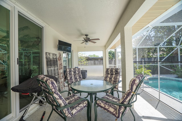 sunroom featuring ceiling fan