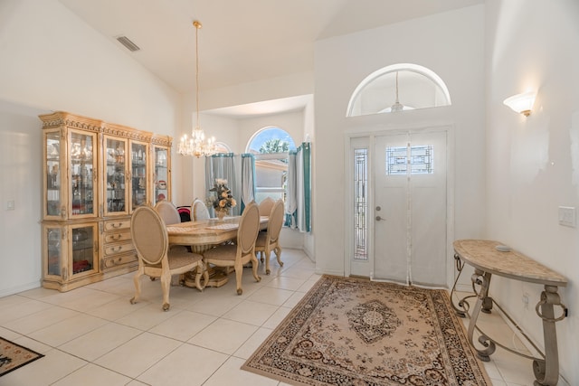 foyer featuring high vaulted ceiling, a healthy amount of sunlight, and light tile floors