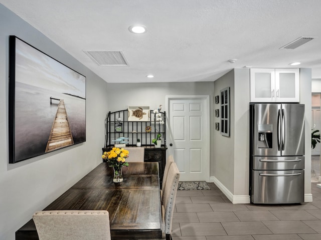 dining space with a textured ceiling