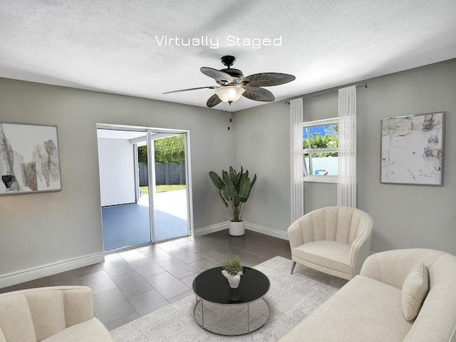 sitting room with a textured ceiling, plenty of natural light, and ceiling fan