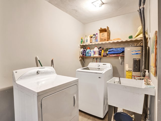 laundry room with independent washer and dryer, a textured ceiling, gas water heater, and sink