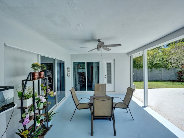 sunroom / solarium featuring ceiling fan