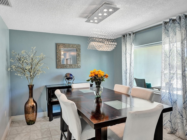 dining room featuring a textured ceiling and a notable chandelier