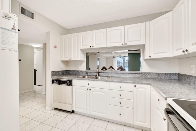 kitchen with light tile floors, white cabinets, white dishwasher, and sink