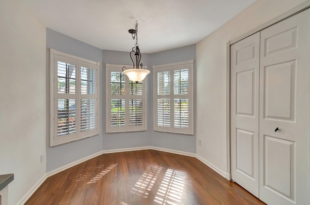 unfurnished dining area featuring dark hardwood / wood-style floors