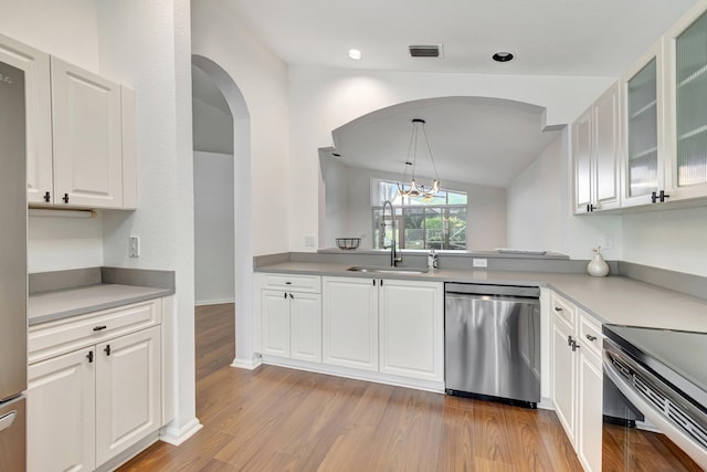 kitchen featuring pendant lighting, sink, light hardwood / wood-style flooring, white cabinetry, and stainless steel appliances