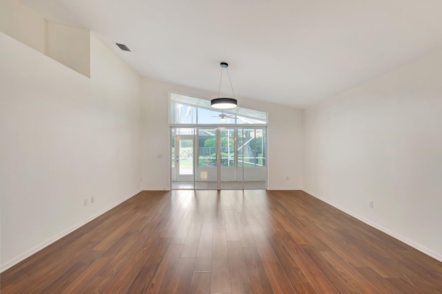 interior space with dark hardwood / wood-style floors and lofted ceiling