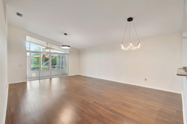 unfurnished room with dark hardwood / wood-style flooring and vaulted ceiling