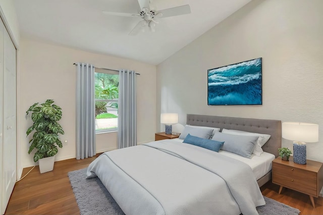 bedroom featuring hardwood / wood-style floors, ceiling fan, a closet, and vaulted ceiling