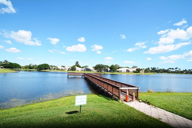 dock area featuring a water view and a yard