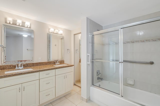 bathroom with shower / bath combination with glass door, tile patterned flooring, and vanity