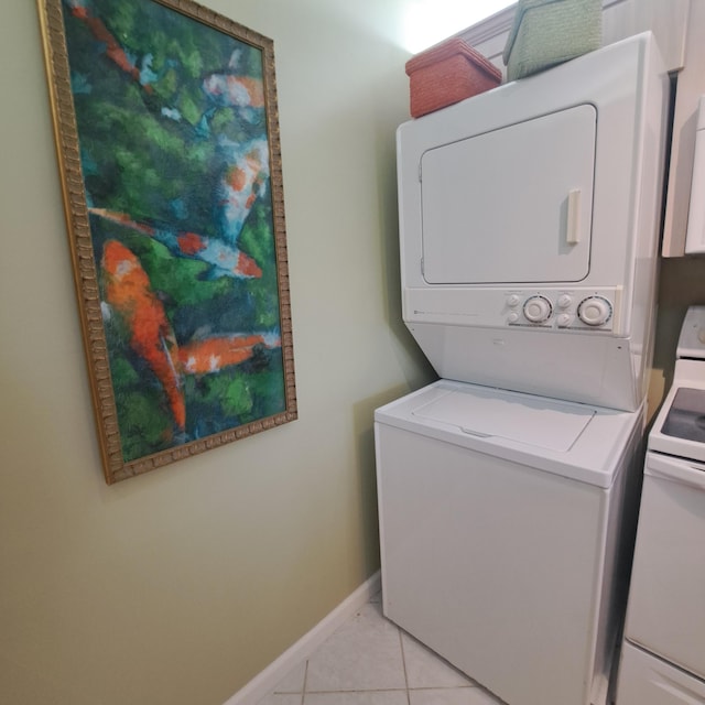 washroom with stacked washer / dryer and light tile patterned floors