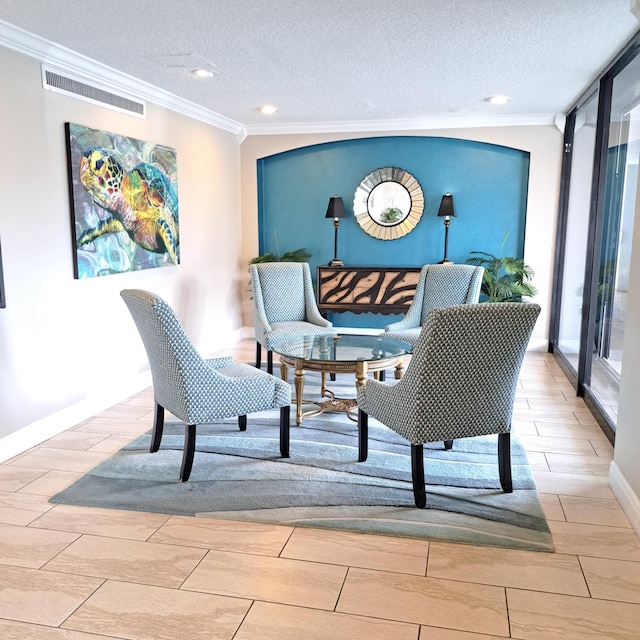 interior space featuring ornamental molding and a textured ceiling