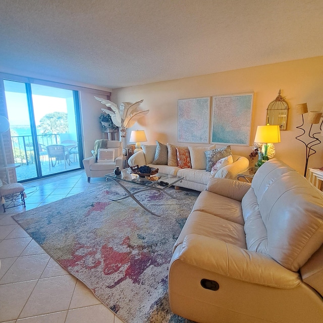 living room with floor to ceiling windows, a textured ceiling, and light tile patterned flooring