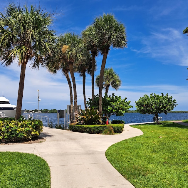 view of home's community with a yard and a water view