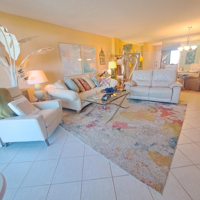 living room with tile patterned floors, a textured ceiling, and a notable chandelier