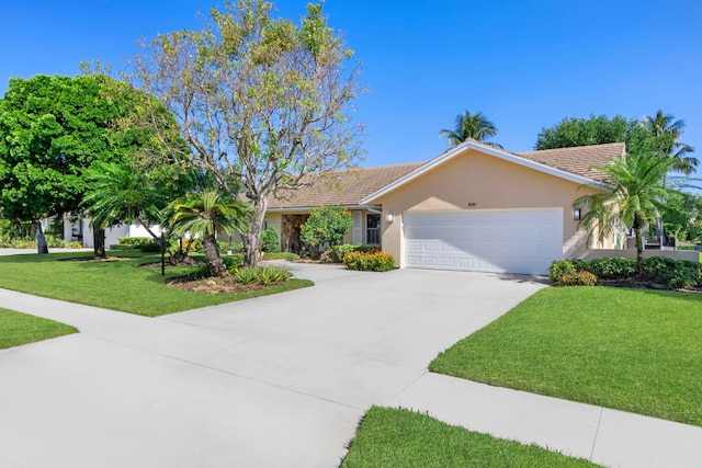 ranch-style house featuring a front yard and a garage