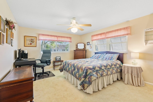 bedroom with light carpet and ceiling fan