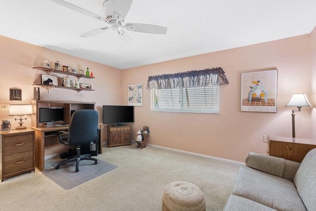 carpeted office featuring ceiling fan