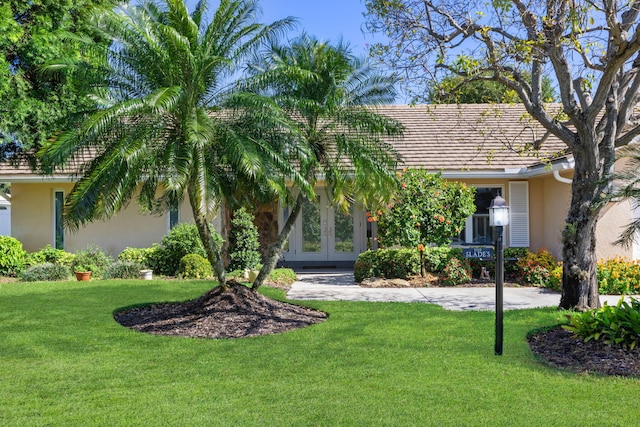 view of front of house with french doors and a front yard