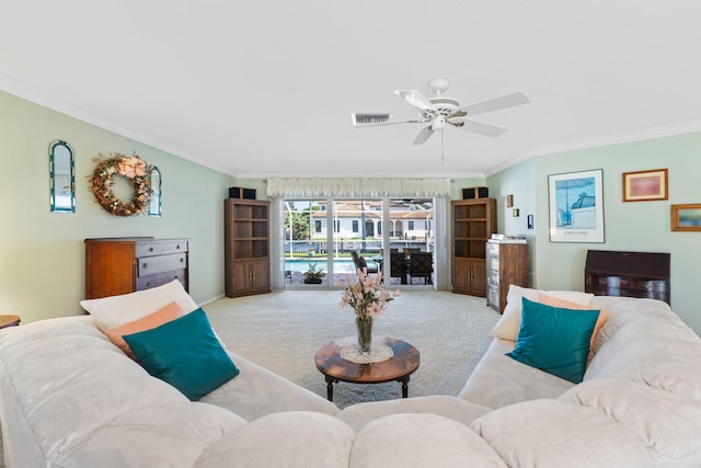 living room featuring ceiling fan, light carpet, and ornamental molding