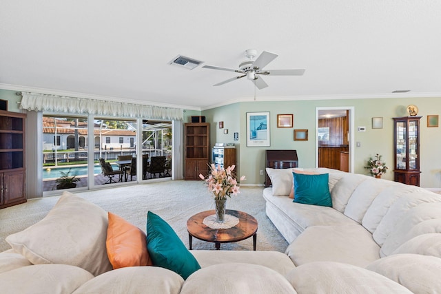 carpeted living room with a healthy amount of sunlight, ceiling fan, and ornamental molding