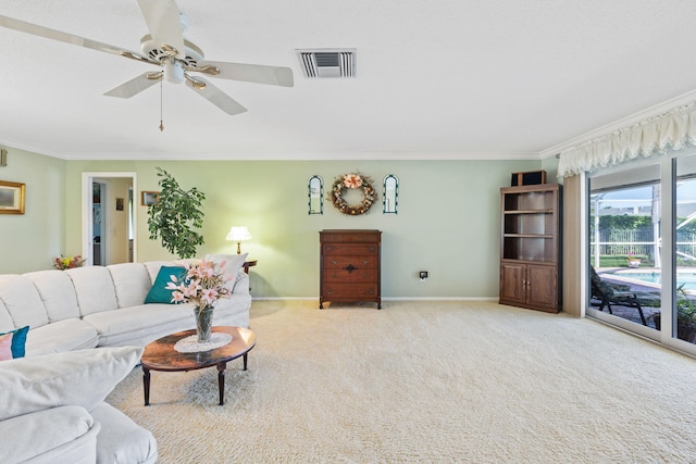 living room with light colored carpet, ceiling fan, and crown molding