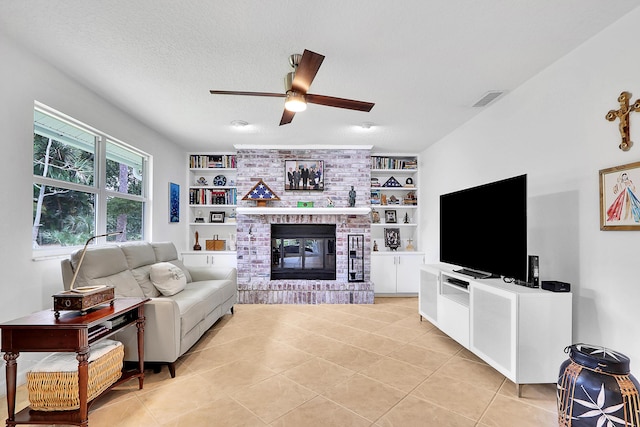 tiled living room featuring a brick fireplace, a textured ceiling, built in features, and ceiling fan