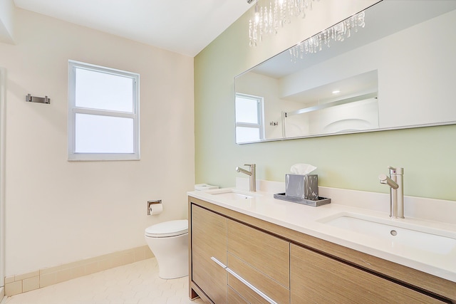 bathroom featuring vanity, toilet, a shower, and tile patterned floors