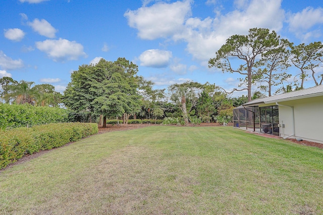 view of yard featuring glass enclosure